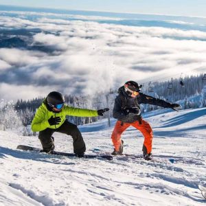 two men on snowboards in sun peaks resort