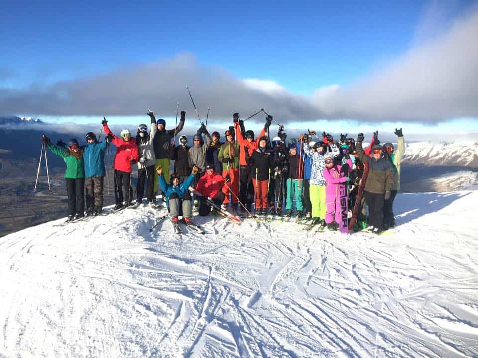 group of instructors with arms in air celebrating WSC course