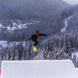 snowboarder doing jump at sun peaks resort