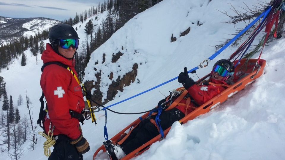 ski patrollers on sled on training course