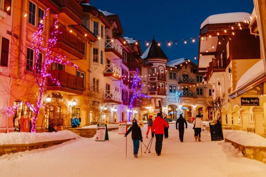 sunpeaks village lit up in colourful lights at night