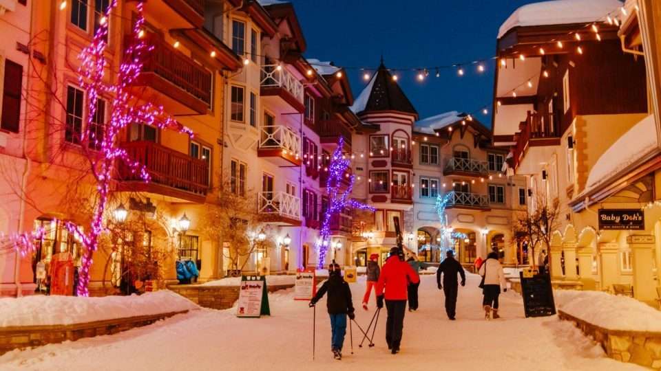 sunpeaks village lit up in colourful lights at night