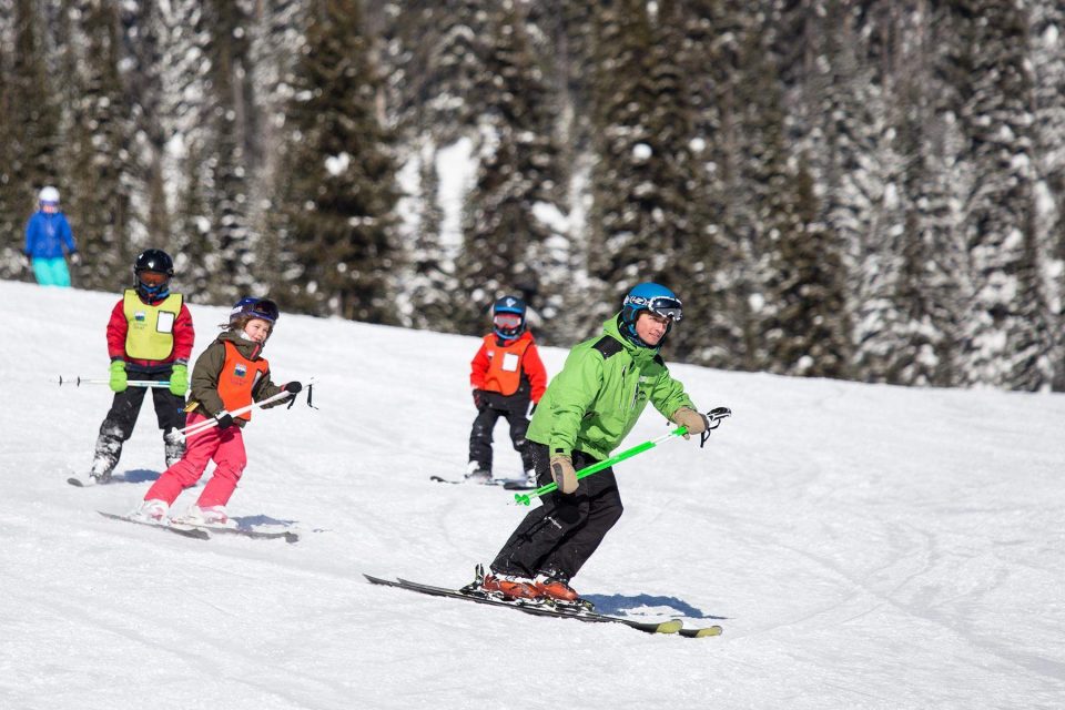ski instructor leading group of kids after WSC internship