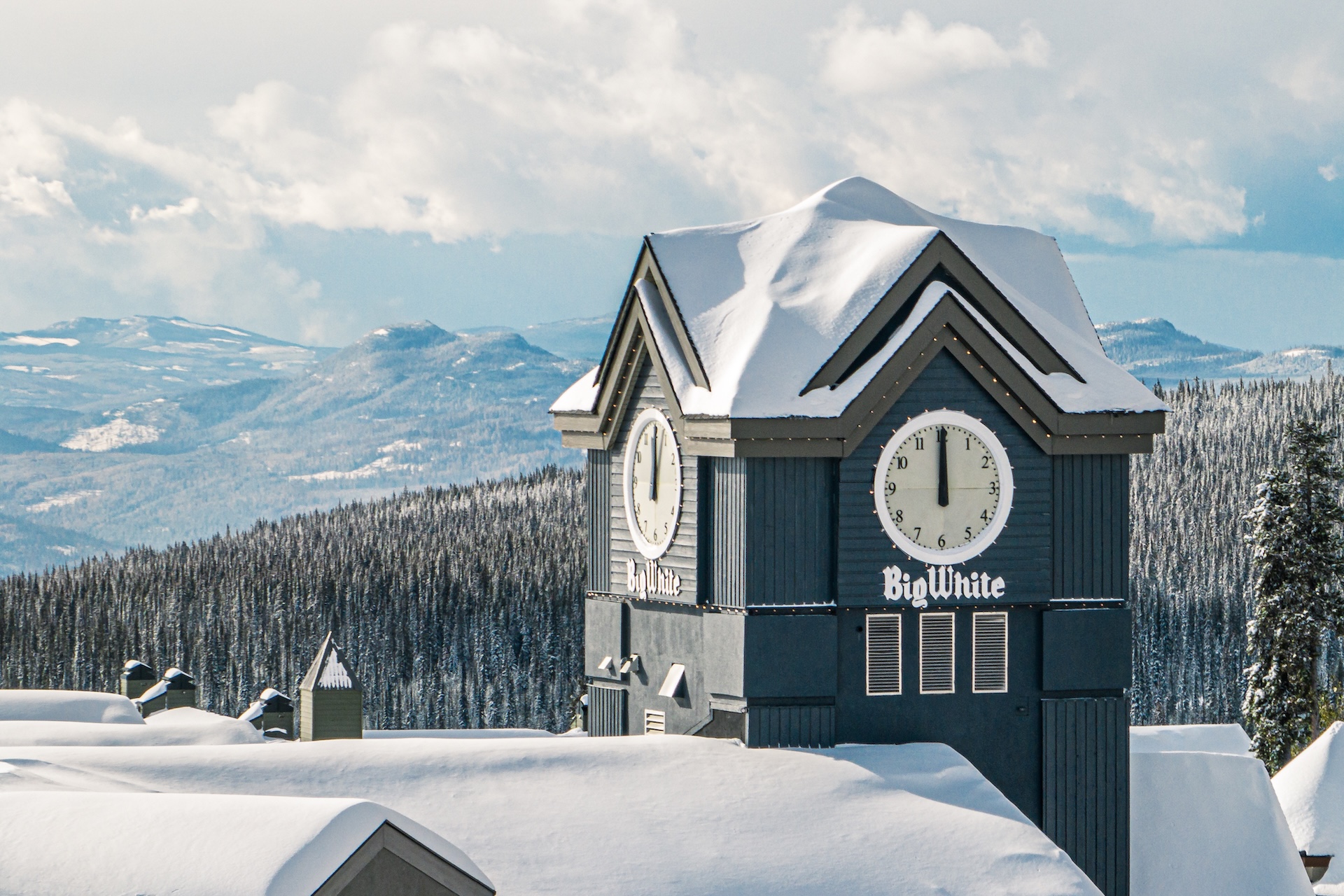 big-white-clock-tower-in-a-snowy-mountain-resort